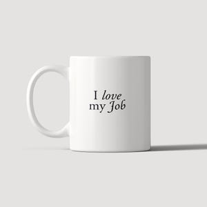 May include: A white ceramic mug with a C-shaped handle featuring the black text "I love my Job" printed in a serif font on the front. The mug has a smooth, cylindrical body and a clean, minimalist design suitable for holding hot or cold beverages.
