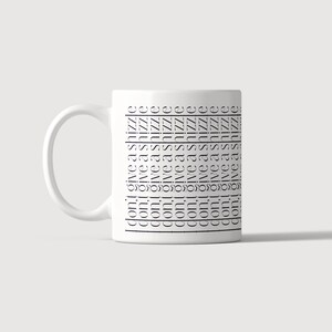 May include: A white ceramic mug with a handle on the left side. The surface features the repeated black text "don't give a shizzle" printed in a clean, sans-serif font, arranged in multiple horizontal rows separated by thin black lines.