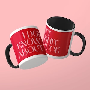 May include: Two ceramic mugs with a bright red exterior and a solid black interior and handle. The mugs feature white text that reads I DON'T KNOW ABOUT SHIT FUCK in a stylized serif font. The design wraps around the exterior of the mugs.