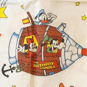 May include: A white ceramic mug with a black handle and the text "But First, Coffee" in a black, bold font. The mug is sitting on a white surface. The mug is a standard size.