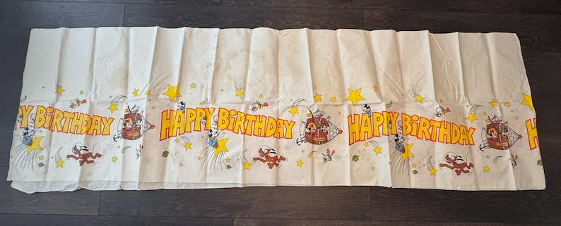 May include: A white ceramic mug with a black handle and the text "But First, Coffee" in a black, handwritten-style font. The mug is on a white surface.