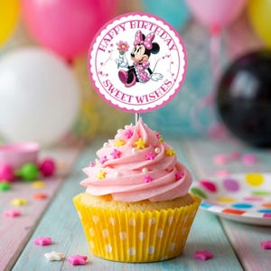 May include: A cupcake with pink frosting, star sprinkles, and a yellow polka-dot liner. A round topper features Minnie Mouse and the text "Happy Birthday Sweet Wishes". Balloons in the background add to the festive theme.