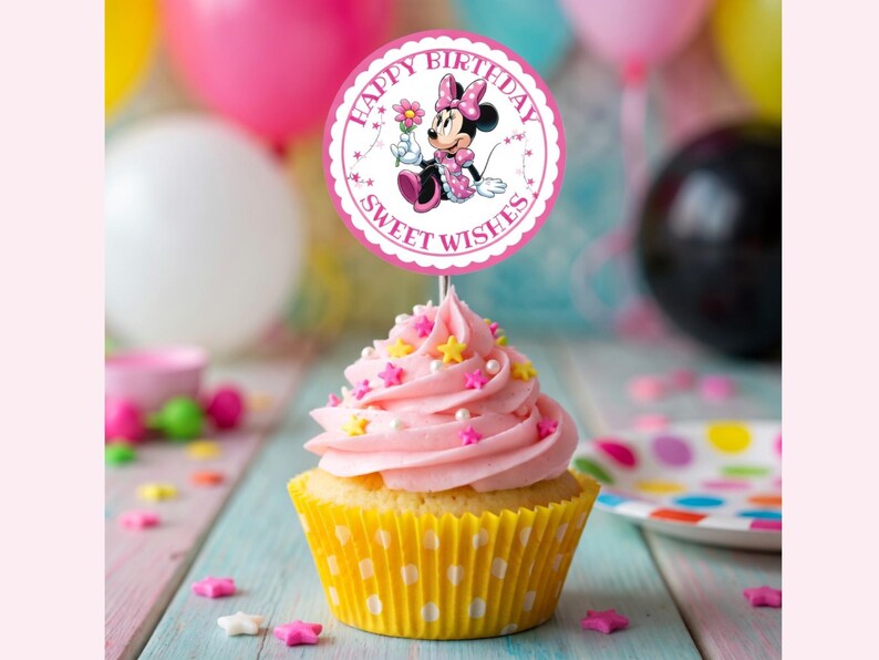May include: A cupcake with pink frosting, star sprinkles, and a yellow polka-dot liner. A round topper features Minnie Mouse and the text "Happy Birthday Sweet Wishes". Balloons in the background add to the festive theme.
