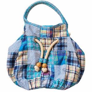 May include: A hobo-style handbag constructed from a patchwork of various blue, white, and yellow plaid fabric squares. The bag features a single top handle, a drawstring closure with thick beige rope, and two smooth wooden beads at the ends.