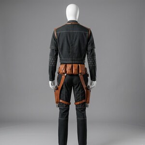 May include: A black jacket and pants ensemble with brown leather accents and holsters. The jacket has light stitching and geometric patterns on the sleeves. The outfit includes a brown leather belt with pouches and leg holsters.