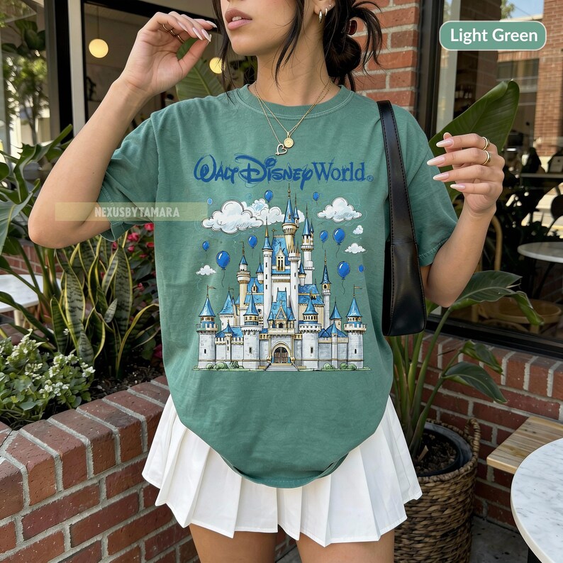 May include: A white ceramic mug with a black handle and the text "But First, Coffee" in a black, handwritten-style font. The mug is on a white surface.