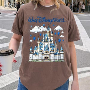 May include: A white ceramic mug with a black handle and the text "But First, Coffee" in a bold, black font. The mug is set against a neutral background, highlighting its simple design. The mug is approximately 4 inches tall.