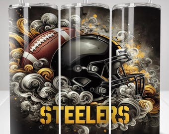 May include: A cylindrical tumbler with a clear straw featuring a football and a black football helmet surrounded by swirling grey and gold smoke patterns. The word STEELERS is printed in bold yellow capital letters at the bottom of the design.