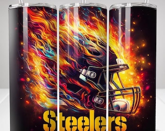 May include: A cylindrical tumbler with a clear straw featuring a graphic of a football helmet engulfed in vibrant, multi-coloured flames against a dark background. The word Steelers is printed in bold yellow lettering at the bottom of the design.