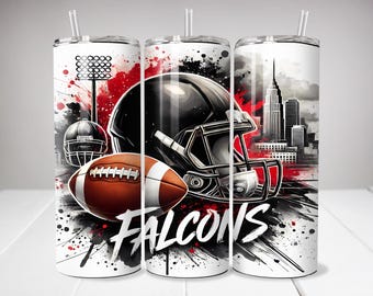 May include: A cylindrical tumbler with a straw featuring a graphic print of a black football helmet, a brown football, a stadium light, and a city skyline. The design includes red and black paint splatters and the word FALCONS in white text.
