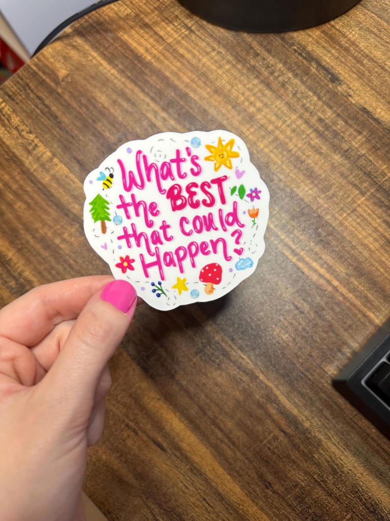 May include: A white die-cut sticker featuring the pink hand-lettered text What's the BEST that could Happen? surrounded by colourful illustrations of a yellow sun, a green tree, a red mushroom, a bee, flowers, stars, and small blue clouds.