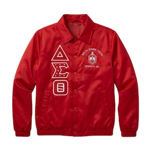 May include: A red satin jacket with a button-up front. White embroidered text and symbols include "Delta Sigma Theta Sorority, Inc." and the Greek letters Delta, Sigma, and Theta. The jacket has a classic collar and long sleeves.