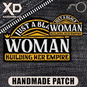 May include: Embroidered patch with the text "JUST A BLACK WOMAN BUILDING HER EMPIRE" in white and yellow on a black background. The patch also has the word "WOMAN BUILDING HER EMPIRE". The patch is labeled "HANDMADE PATCH".
