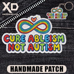 May include: Embroidered patch with the text "CURE ABLEISM NOT AUTISM" in colorful letters. The patch features a rainbow infinity symbol and a small heart. A keychain with the same design is also visible.