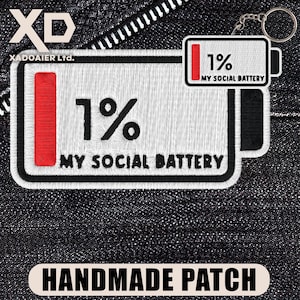 May include: Embroidered patch with a battery design showing 1% charge, labeled "MY SOCIAL BATTERY." The patch is white with black and red accents, and includes a keychain. The text "HANDMADE PATCH" is at the bottom.