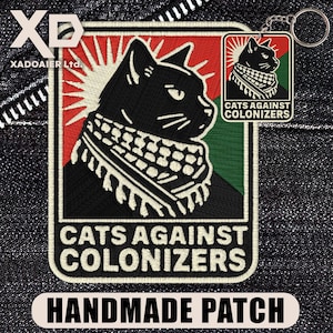 May include: Embroidered patch and keychain with a black cat wearing a scarf, set against a red, green, and white background. The text "CATS AGAINST COLONIZERS" is displayed. The patch is labelled "HANDMADE PATCH".