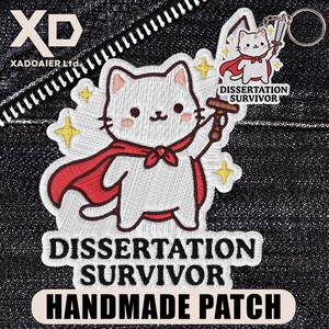 May include: Embroidered patch featuring a white cat wearing a red cape and holding a gavel. The patch reads "Dissertation Survivor" and "Handmade Patch". A small keychain with a cat holding a sword is also visible.