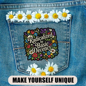 May include: A denim pocket adorned with daisies and a floral patch that reads "Radicalized by Basic Decency." The phrase "MAKE YOURSELF UNIQUE" is at the bottom. The patch features colorful flowers and foliage.