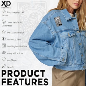 May include: A light blue denim jacket with a black and white patch featuring an illustration of a bird. The image also displays product features, including "Easy to Apply to All Fabrics" and "Washing Machine Safe."