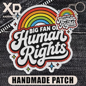 May include: Embroidered patch with the text "BIG FAN OF Human Rights" and a rainbow design. A matching keychain is also visible. The patch has a red border and the words "HANDMADE PATCH" are at the bottom.