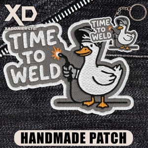 May include: Embroidered patch and keychain featuring a cartoon duck welding. The patch reads "TIME TO WELD" in gray lettering. The duck is white with an orange beak and feet, holding a welding torch. The keychain has a smaller version of the duck.