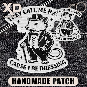 May include: Embroidered patch and keychain featuring a cartoon rat in a suit and hat, holding a cane. The patch reads "THEY CALL ME RANCH CAUSE I BE DRESSING" and "HANDMADE PATCH". The keychain has the same rat design.
