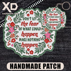 May include: Embroidered patch and keychain set with the text "DON'T LET the fear of what could happen MAKE NOTHING happen." The design features red, pink, and orange flowers with green leaves on a white background.