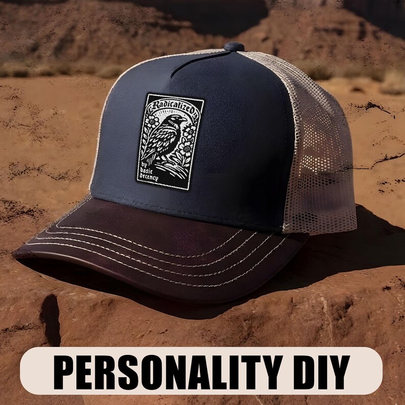 May include: A navy blue and brown trucker hat with a white mesh back. The front panel features a patch with a black and white bird illustration and the words "Radicalized by basic decency."