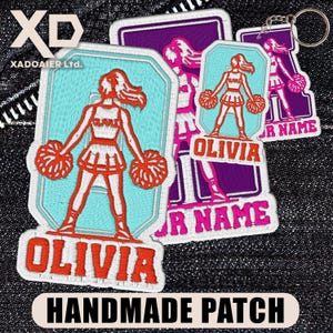 May include: Embroidered patches with a cheerleader design and the name "OLIVIA" in orange. The patches are in shades of blue, pink, and purple, with the text "HANDMADE PATCH" at the bottom. A keychain version is also visible.