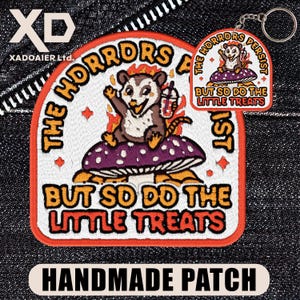 May include: Embroidered patch with a cartoon opossum on a mushroom, surrounded by flames. Text reads "THE HORRORS PERSIST BUT SO DO THE LITTLE TREATS." A matching keychain is also visible. The patch is handmade.