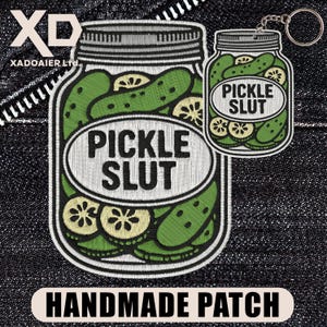 May include: Embroidered patch and keychain featuring a jar of pickles with the text "PICKLE SLUT". The patch and keychain are green, white, and black. The patch has the words "HANDMADE PATCH" at the bottom.