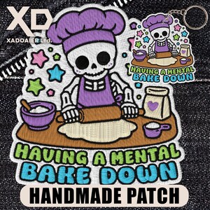 May include: Embroidered patch featuring a skeleton chef rolling dough, wearing a purple chef's hat and apron. The patch includes the text "HAVING A MENTAL BAKE DOWN HANDMADE PATCH" in green and blue. A smaller keychain version is also visible.