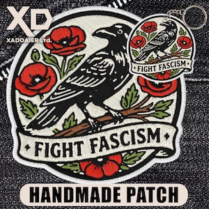 May include: Embroidered patch featuring a black raven perched on a branch, surrounded by red poppies and green leaves. The text "FIGHT FASCISM" is displayed on a banner. A matching keychain is also visible. The patch is labeled "HANDMADE PATCH".