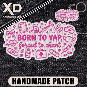 May include: A handmade patch and keychain with a medical theme. The patch is white with pink embroidered medical icons and the text "BORN TO YAP, forced to chant." The keychain has the same design. The background is a dark denim fabric.