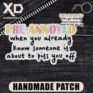 May include: Embroidered patch with the text "PRE-ANNOYED" in pastel colors, with the phrase "when you already know someone is about to piss you off." A smaller keychain with the same text is also visible. The patch is labeled "HANDMADE PATCH."