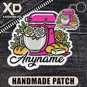 May include: An embroidered patch and a matching keychain featuring a pink stand mixer, yellow and white roses, loaves of bread, and a stick of butter. The text Anyname is embroidered in black script on the patch and the keychain. The design is on a dark denim fabric.