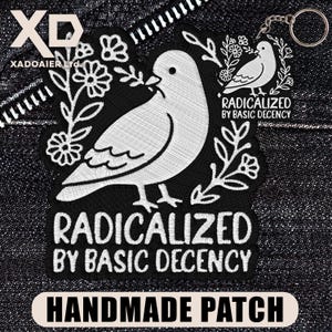 May include: Black and white embroidered patch featuring a dove with a sprig in its beak, surrounded by floral elements. The text "RADICALIZED BY BASIC DECENCY" is displayed. The bottom of the patch reads "HANDMADE PATCH".