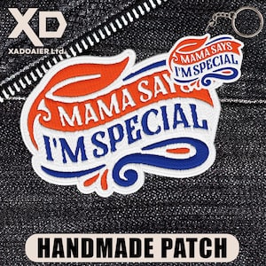 May include: Embroidered patch with the text "MAMA SAYS I'M SPECIAL" in white, orange, and blue. The patch is on a dark denim background. A smaller keychain patch with the same text is attached. The words "HANDMADE PATCH" are at the bottom.