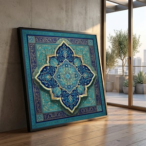 May include: A framed square artwork with an intricate, symmetrical design in teal, blue, and gold. The artwork has a central medallion shape with floral and geometric patterns. The black frame contrasts with the artwork, leaning against a concrete wall.