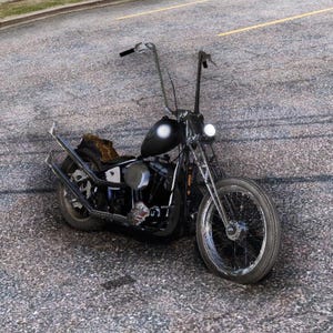 May include: A black custom chopper motorcycle with high handlebars and a teardrop fuel tank. The motorcycle has a chrome front wheel, a solo seat, and a custom exhaust. The bike is parked on a gray asphalt surface.