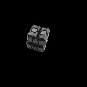 May include: A dark grey, geometric object with a textured surface. The object is made of stacked, rectangular blocks. The background is solid black, emphasising the object's form and shape.