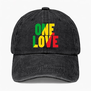 May include: Black denim baseball cap with the words "ONE LOVE" in green, yellow, and red. The cap has a curved brim and an adjustable strap at the back. The hat is a casual accessory.