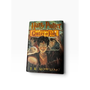 May include: A hardcover book titled Harry Potter and the Goblet of Fire by J.K. Rowling. The cover features a central illustration of a young person with round glasses, surrounded by other characters and a glowing wand against a dark background.