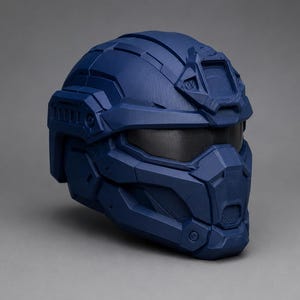 May include: A matte navy blue tactical helmet featuring a multi-paneled geometric design, a dark tinted visor, and a reinforced front faceplate with integrated ventilation details. The helmet has a structured shell with raised ridges and grooves.
