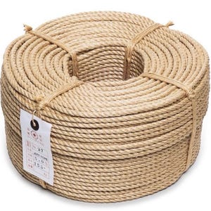May include: Coiled jute rope, tightly wound and secured with twine. A white tag with Japanese text is attached. The natural tan color of the rope is visible, suggesting a durable and rustic material, suitable for various crafting and utility purposes.