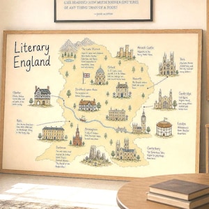 Könnte beinhalten: Eine gerahmte Karte mit dem Titel Literary England, die Illustrationen historischer Wahrzeichen und Städte wie London, Oxford und York zeigt, mit beschreibendem Text für jeden Ort auf hellgelbem Hintergrund in einem Holzrahmen.