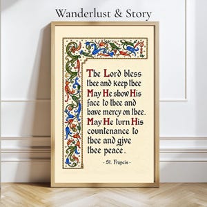Pode incluir: Uma impressão emoldurada com o texto The Lord bless thee and keep thee May He show His face to thee and have mercy on thee. May He turn His countenance to thee and give thee peace. - St. Francis - com uma borda floral colorida.