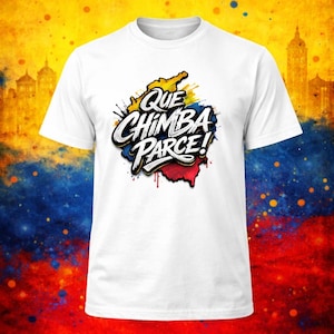 May include: A white short-sleeved t-shirt featuring a central graphic design of the text Que Chimba Parce in bold white lettering with a black outline, layered over a stylized map shape filled with yellow, blue, and red paint splatter colors.