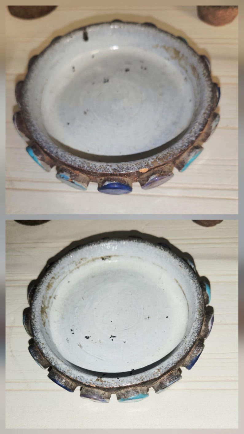 May include: A small, round, antique ceramic dish with a white interior and a decorative, scalloped rim. The rim is a mix of brown, blue, and turquoise accents. The dish has a rustic, aged appearance.