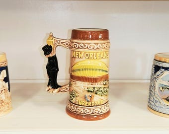 Three  Souvenir Beer Steins New Orleans Superdome, Plymouth, Massachusetts, Wet Your Whistle all EUC Ceramic with Unique Handles